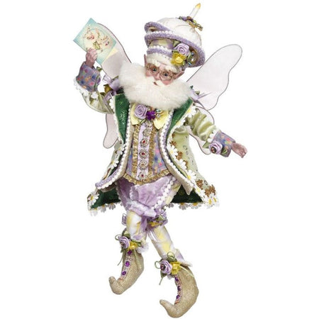 Fairy with a green & purple outfit on & a cake on its hat.