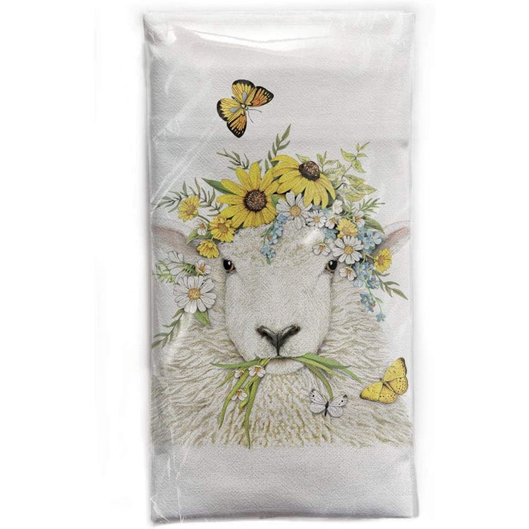 Flour sack towel with a sheep in a flower crown and some butterflies.