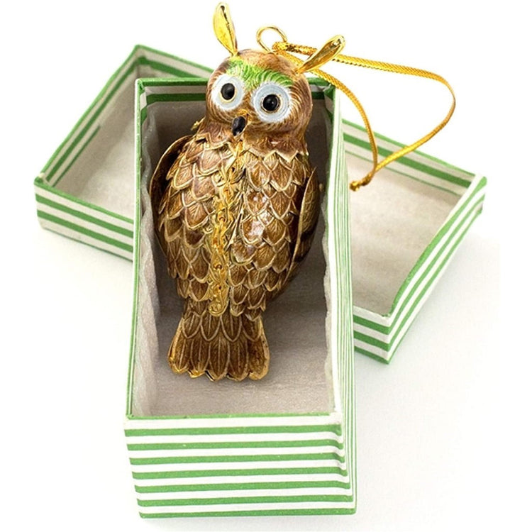 A brownish-gold colored owl with a speck of green in its head.