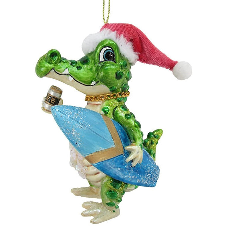 Green alligator with a Santa hat on holding a surfboard & beer in its hand. 