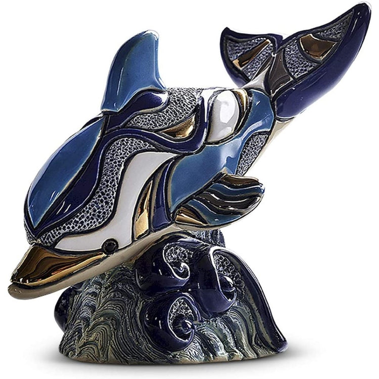 Diving dolphin figurine on a wave.