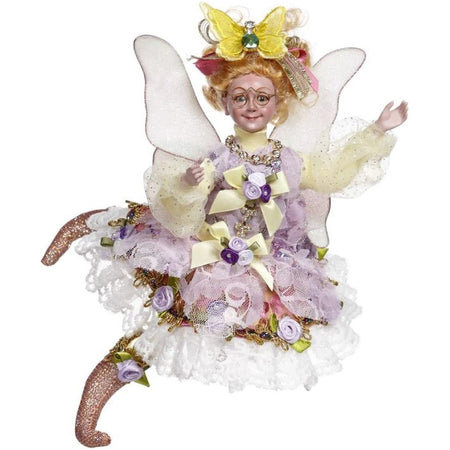 Red haired fairy wearing purple dress with wings.