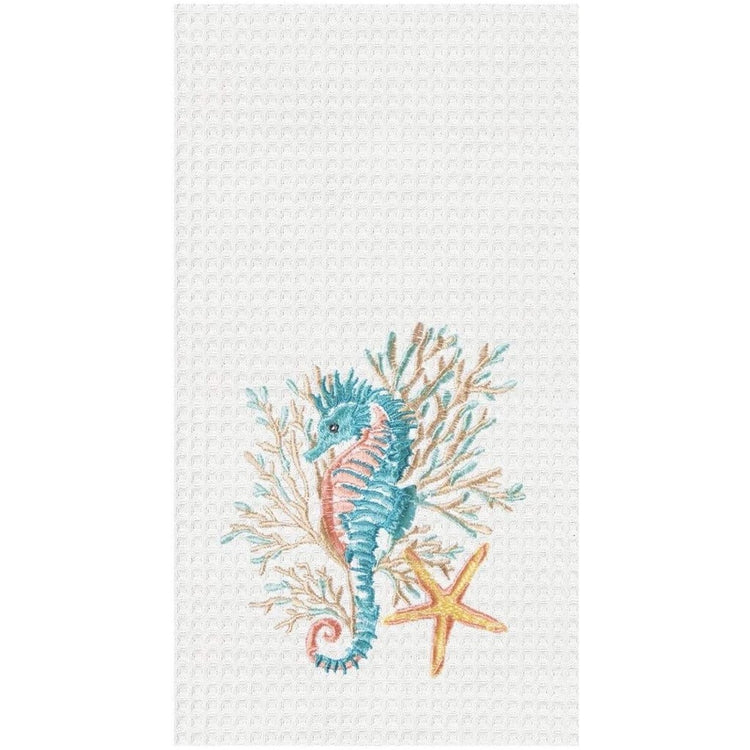 white waffle weave towel with embroidered blue seahorse, coral, and yellow starfish.