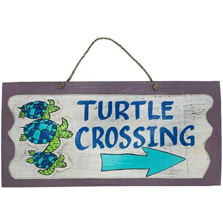 rectangular wood sign on a rope hanger, says "turtle crossing" with an arrow and three turtles.