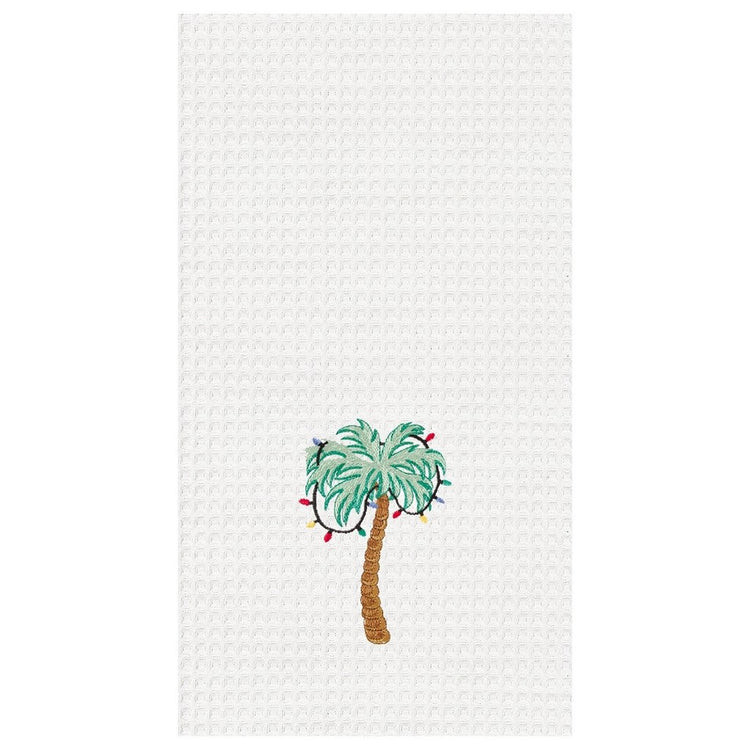 White waffle weave towel with a green palm tree with colorful Christmas lights in it.