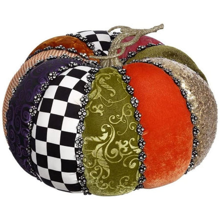 pumpkin figurine with sections of purple, pink, orange and green velvet, black and white checks, gold sequins, all separated by silver rhinestones.
