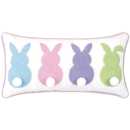White rectangular pillow with pastel embroidered back view of 4 bunnies with tails.