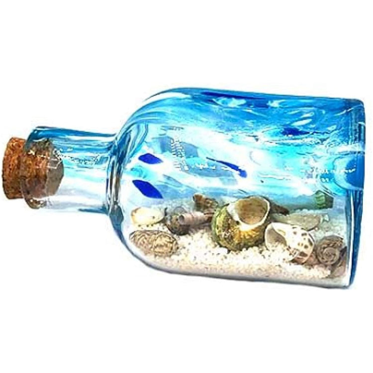 Glass clear & blue message in a bottle with sand & shells.
