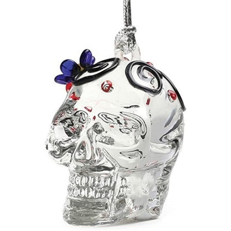 Clear ornament with a blue flower on it head. 