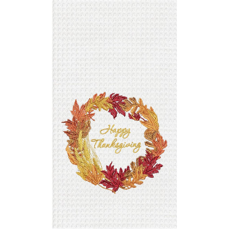 white cotton waffle weave towel with fall foliage wreath and the words Happy Thanksgiving embroidered on it.