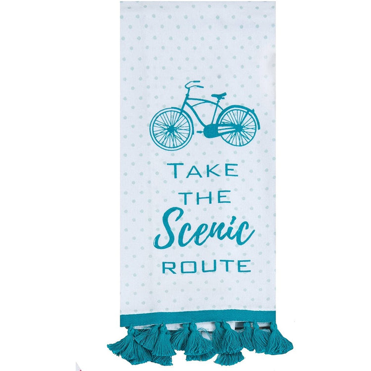 White towel with teal dots, bike, "take the scenic route" & tassels on it.