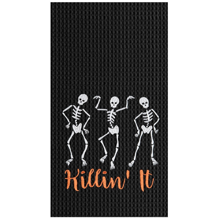 Black waffle weave dishtowel with white embroidered skeletons and orange embroidered words "Killin' It"