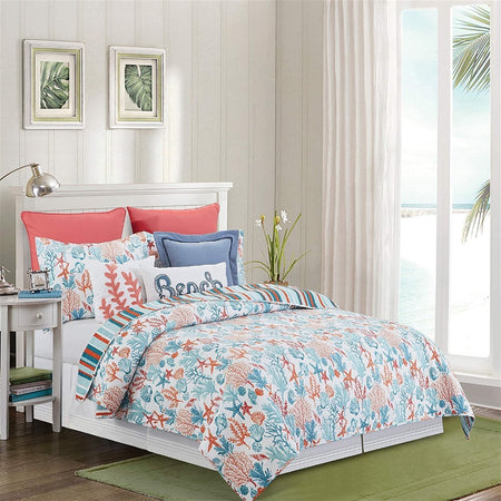 White quilt with fish, coral, shells & seaweed in blue, teal & orange. 