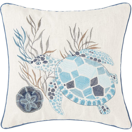 Tan pillow with blue & white turtle & coral & a sandollars. 