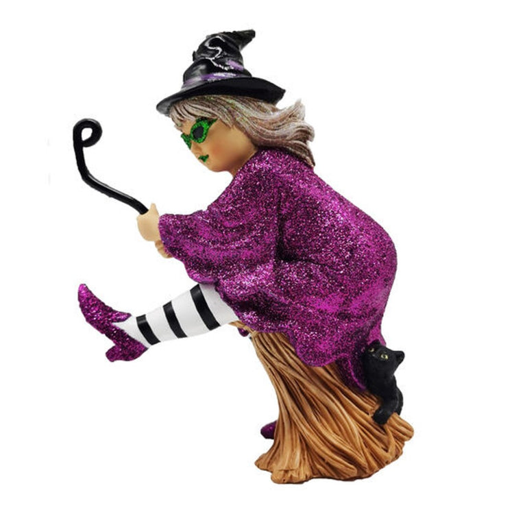 Witch in a black hat, striped stockings. glittery purple cape & shoes riding a broom.