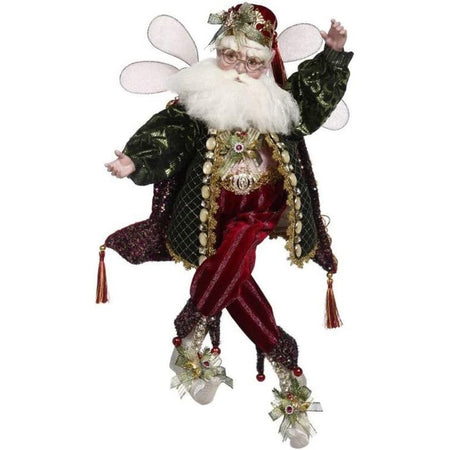 christmas fairy with white beard and glasses. Wearing green beaded jacket and red pants. White shoes with bows and berries.