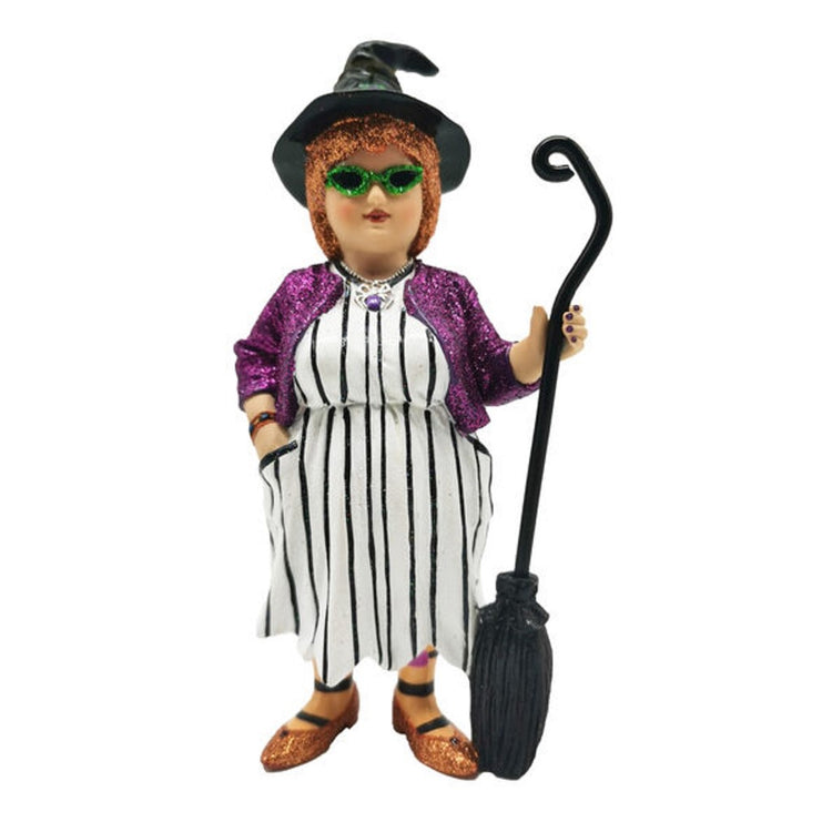 Witch with glittery orange hair, black hat and broom. She is wearing a black and white striped dress, glittery purple jacket, and orange glittery shoes.