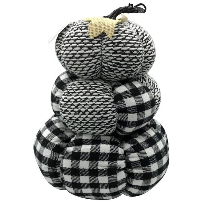 Stack of 3 pumpkins make of a white, grey and black pattern cloth material. A short cloth vine & leaf is on top of the stack