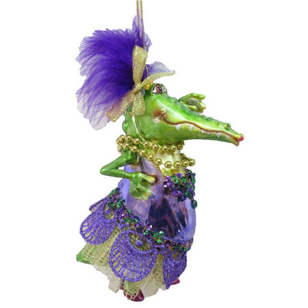 Female alligator figurine ornament.  She is wearing Mardi Gras beads with purple and green outfit.