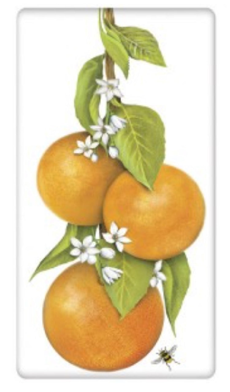 White flour sack towel with 3 oranges on a branch with orange blossoms and a bee flying around.