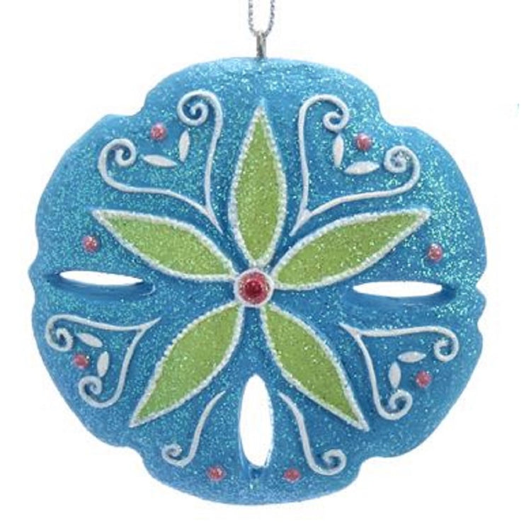 Blue glitter sand dollar ornament with green center pattern. Red bead in center and around edge.