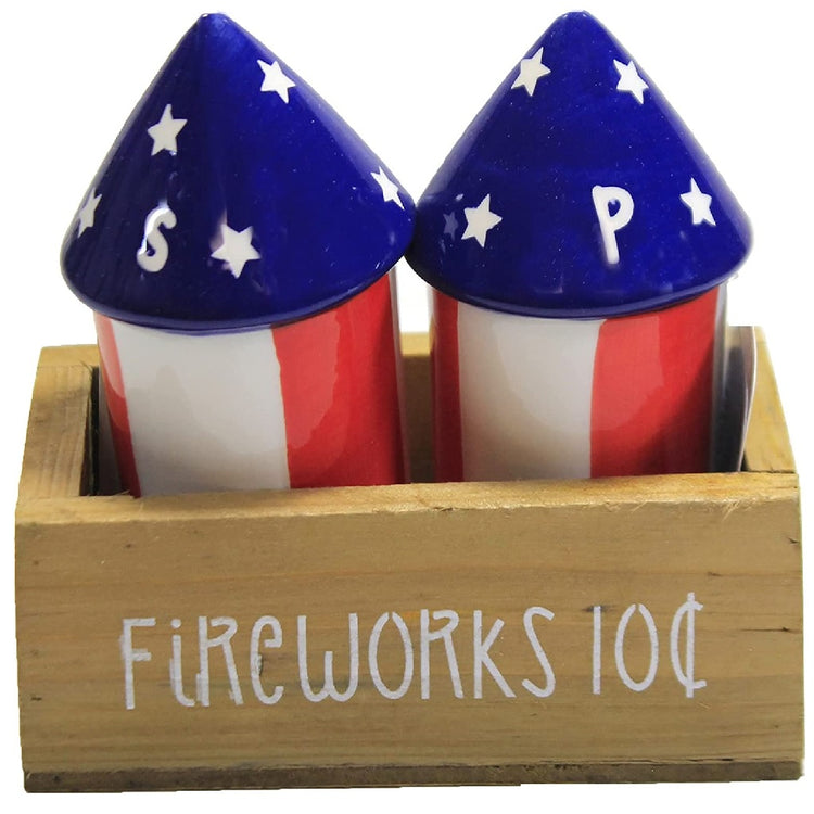 two red white and blue firework shaped salt and pepper shakers in a brown wooden crate style tray.