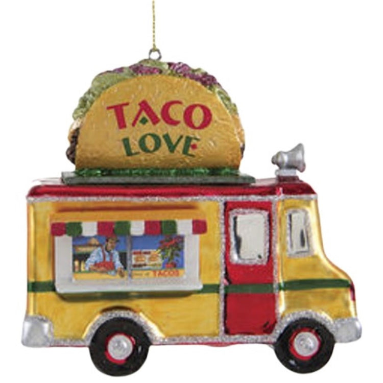 Blown glass ornament of a yellow food truck with red door and roof. There's a large taco on top with the words Taco Love.