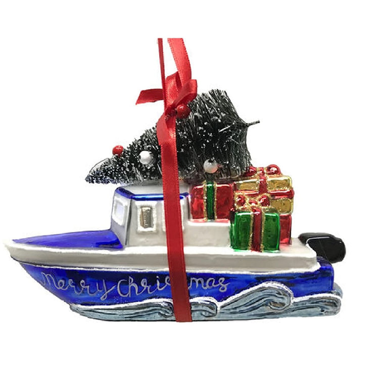 Boat ornament with waves on side. Blue boat has gifts on deck and a tree on top of main cabin