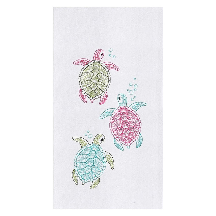 White towel with 3 baby turtle designs. 1 is pink and green, 1 is pink and blue, 1 is green and blue.