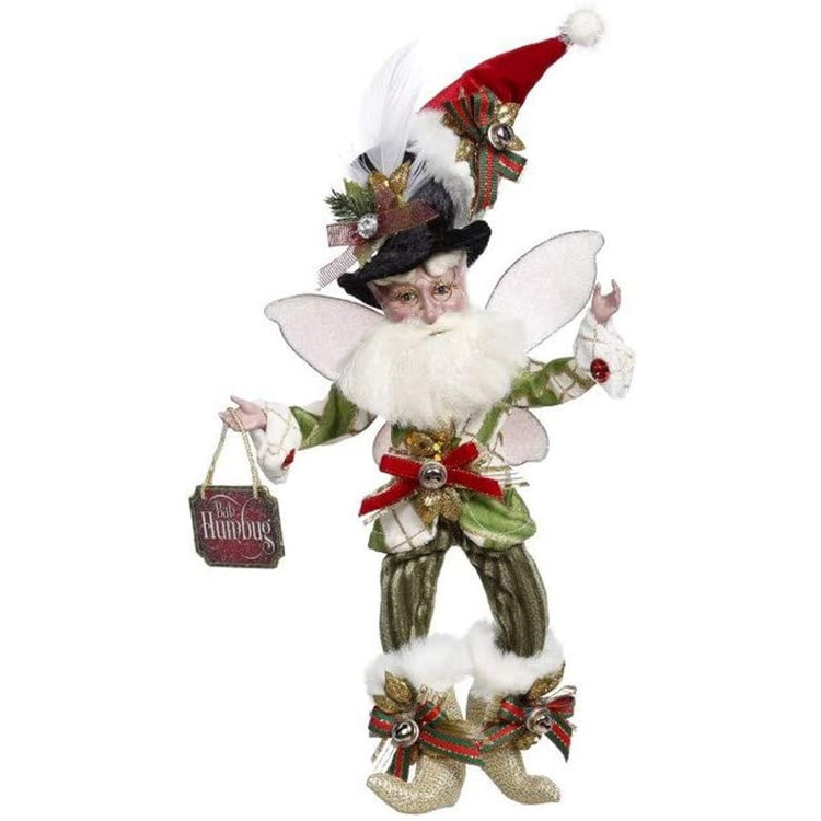 bearded fairy in a top hat with a santa hat on top, green pants and a green plaid jacket. He's holding a sign that says "bah humbug"