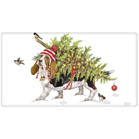 Folded dishtowel with a basset hound print.  Dog is carrying a Christmas tree on his back with 2 birds in photo.