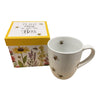 White mug with scattered bee design, next to a gift box showing a wildflower garden and the phrase "plant these to save the bees."