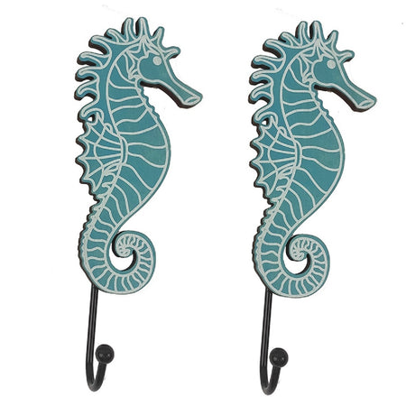 2 identical towel hooks. Seahorse shape in aqua blue. The  seahorse is wood with metal hooks. 
