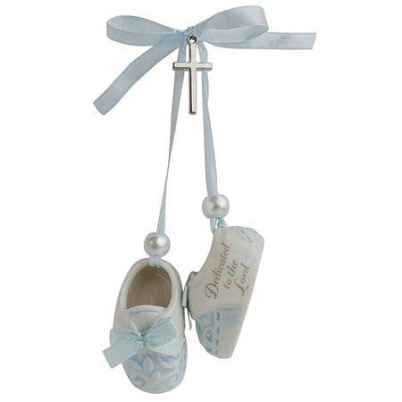 Pair of blue baby shoes with metal cross and blue ribbon. "Dedicated to the Lord" print on side.