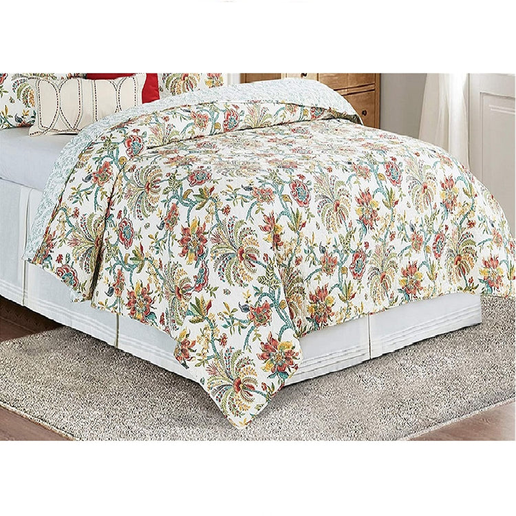 comforter with white or off white background and orange, rust, yellow an dgreen flowers and palm type trees.