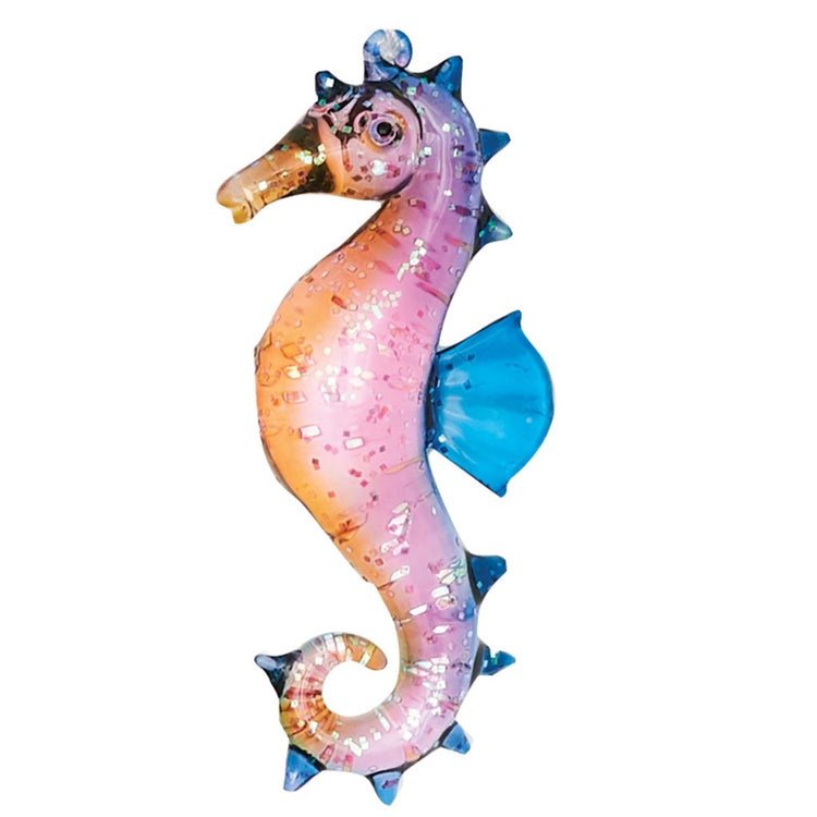Seahorse shaped Christmas ornament with orange, pink and blue shades.