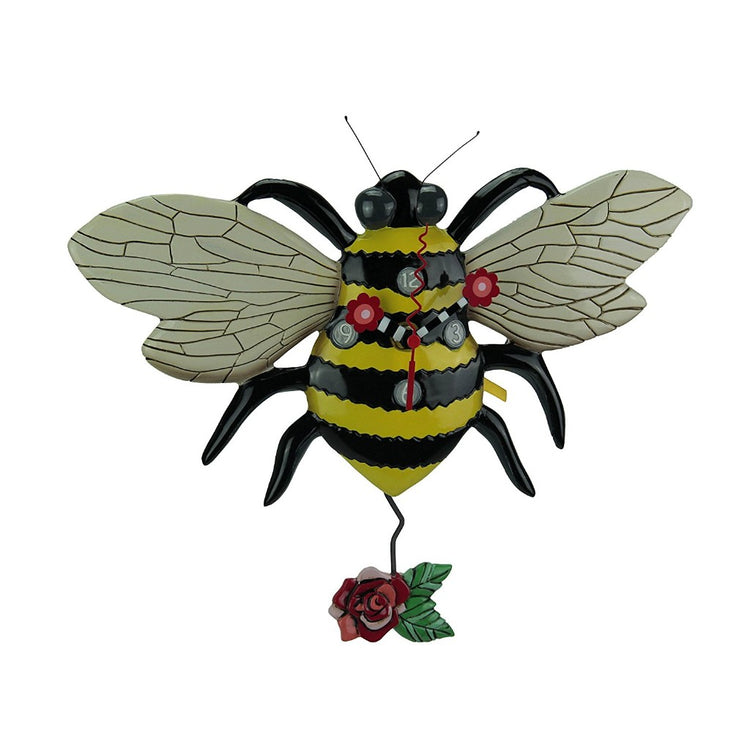 Bumble bee shaped clock with flower pendulum.  White wings with yellow and black body.