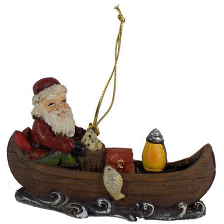 Santa sits in a canoe holding a fishing pole & basket of fish. Lantern in the front with a fish jumping beside the canoe.
