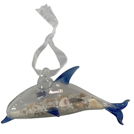 Clear glass dolphin half full of small shells & sand. Nose, fins & tail are blue. White ribbon hanger is connected to back.