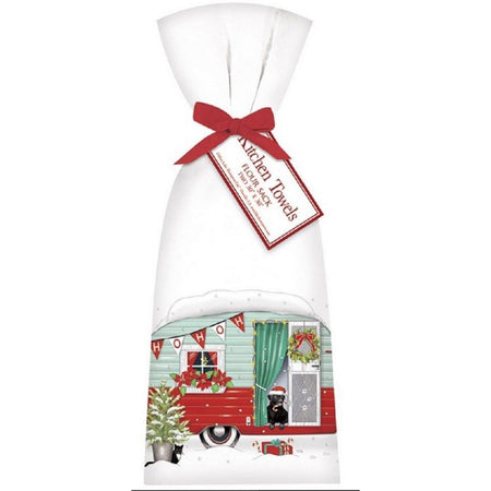 2 white towels tied with a red ribbon. Towel shows a green and red vintage camper, a black dog, and a fir tree in the snow. 