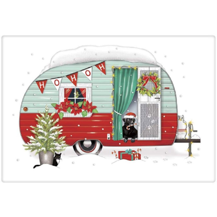 White dishtowel with red and green camper.  Black lab dog wearing a Santa hat sits in doorway.  It is snowing.