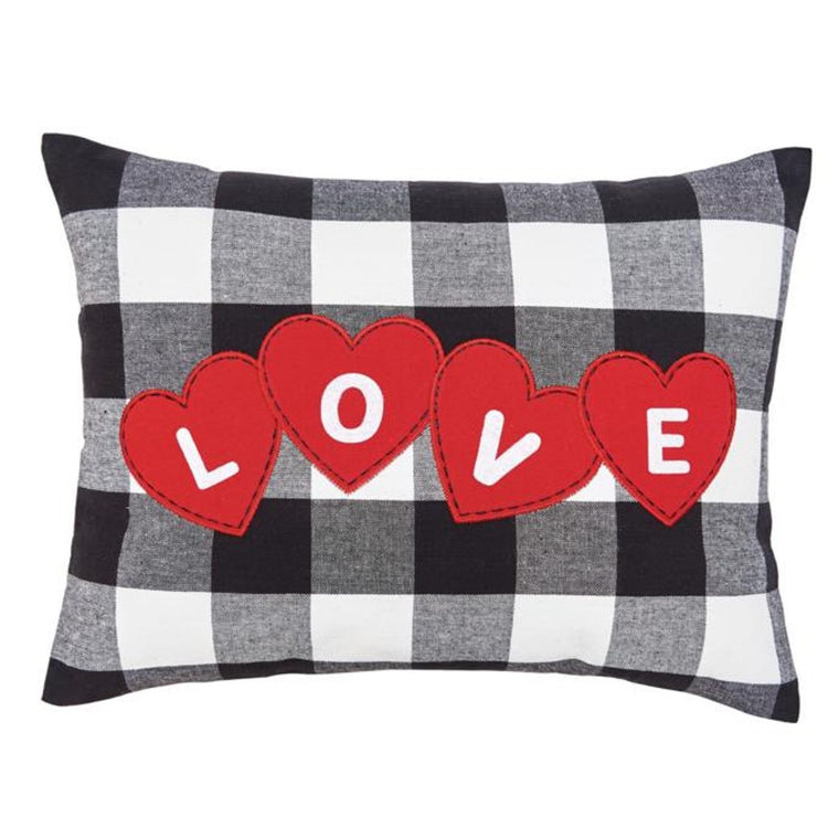 Black & white plaid pillow with 4 red hearts that spell out LOVE.