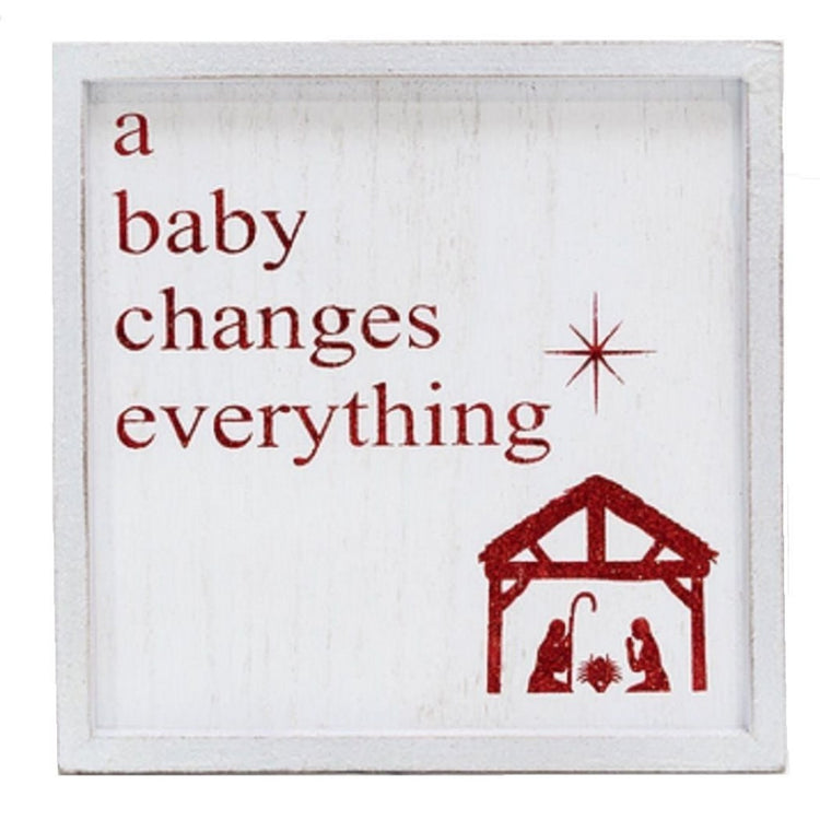 White wood shadow box with red glitter lettering. A baby changes everything. Also shows nativity and star.