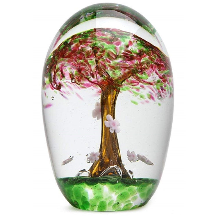 Clear glass paperweight figurine with cherry tree encased under clear.