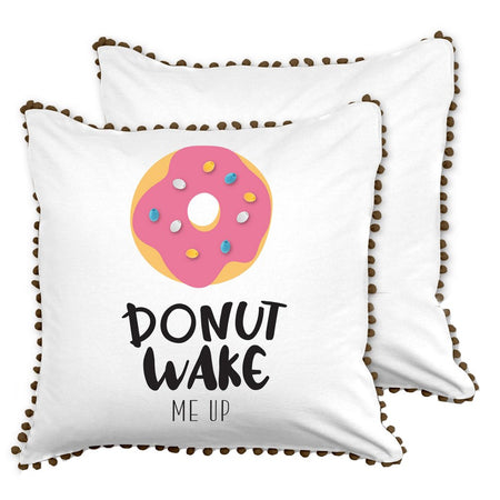 Square white pillow with black fringe, donut design on front " DONUT WAKE ME UP".