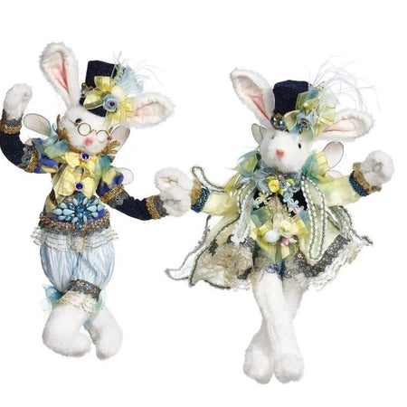 2 Rabbit figures dressed in festive clothing. The male is wearing blue with yellow ribbons and the female is wearing yellow with blue accents.  Both wear a top hat in black.