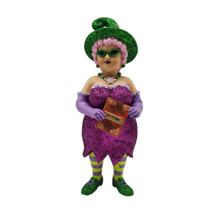 Witch with light pink hair, green sparkly shoes & hat. She's wearing a sparkly purple dress, purple gloves, and purple & green tights. She's holding a potions book.