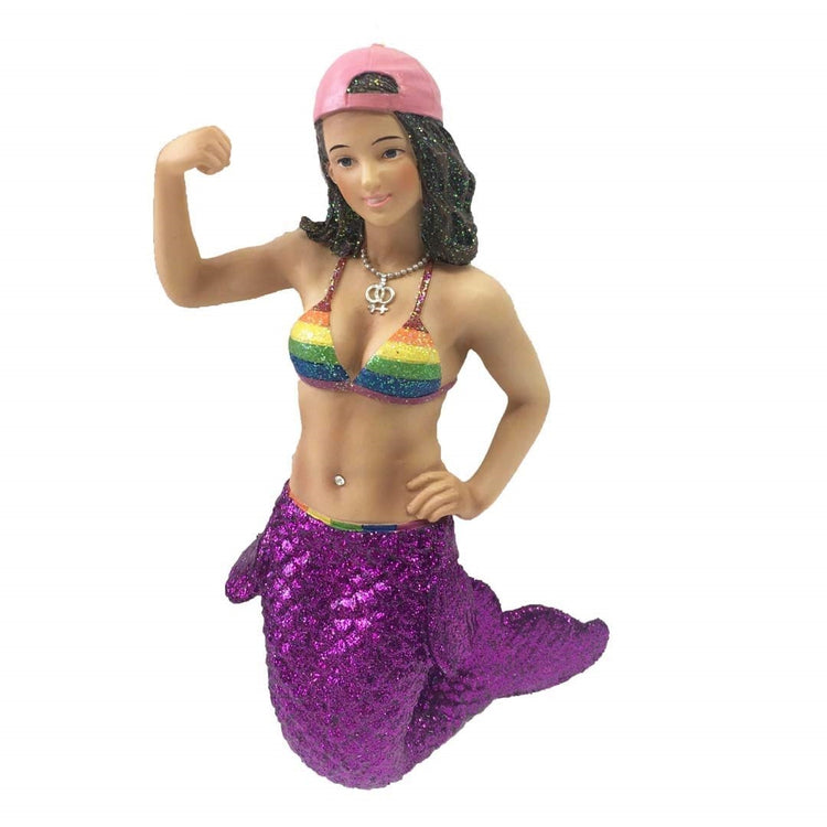 Mermaid figurine hanging ornament.  She has a purple tail and rainbow colored bathing suit top.  Pink baseball cap on backwards she is in a bicep muscle pose.