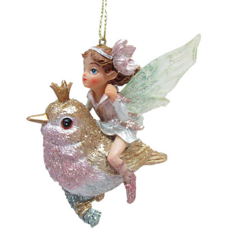 resin ornament of a small girl fairy riding a gold and pink bird wearing a crown.