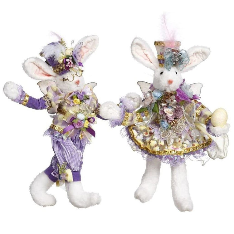 white bunny figurines with wings, in lavender purple suit and dress.
